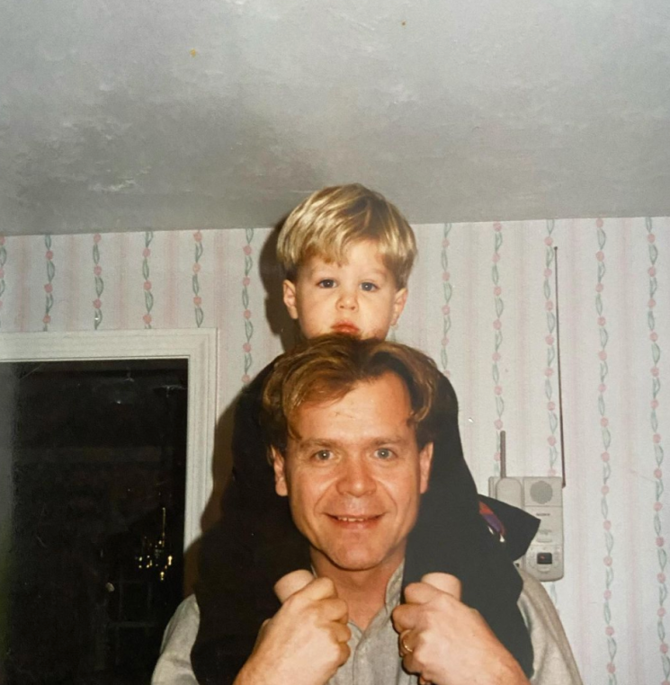 Baby Eric sitting on the shoulder of his dad